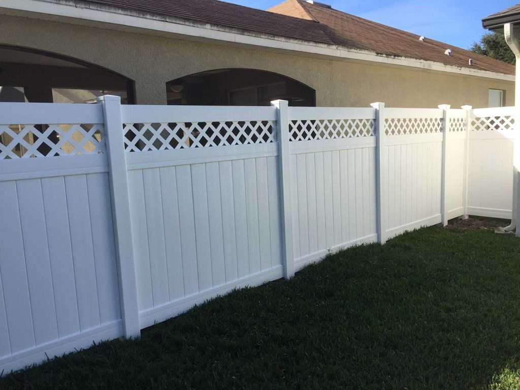 a white vinyl lattice fence