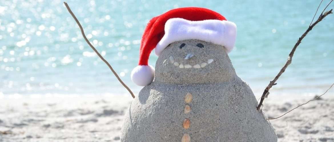 a snowman made of sand on a beach