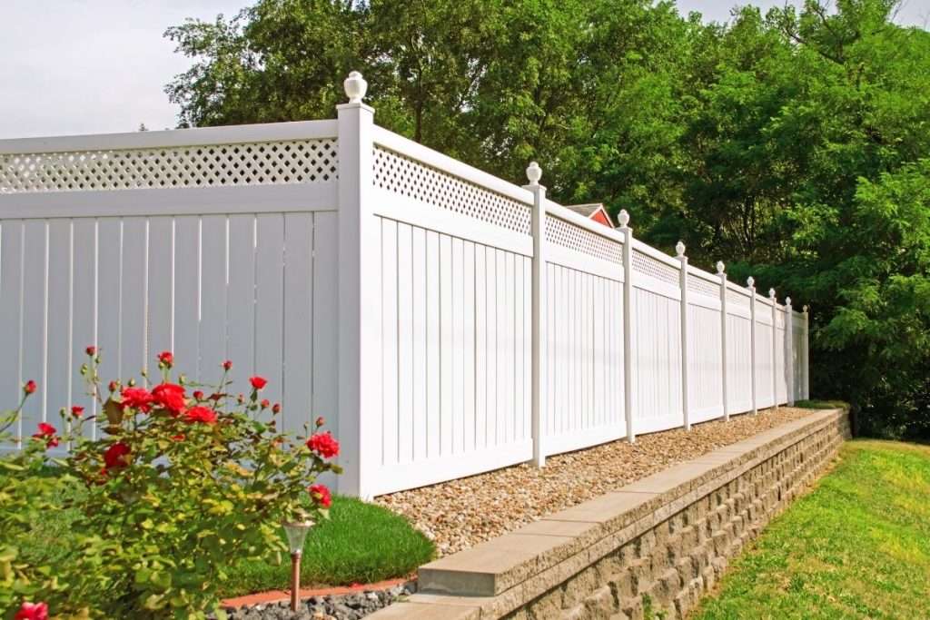 a white vinyl fence in the backyard of a Tampa home